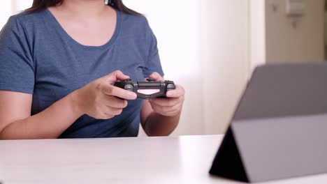 women hand playing video games happy and exciting emotion in at home