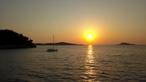 sunset in croatia with boat sailing past