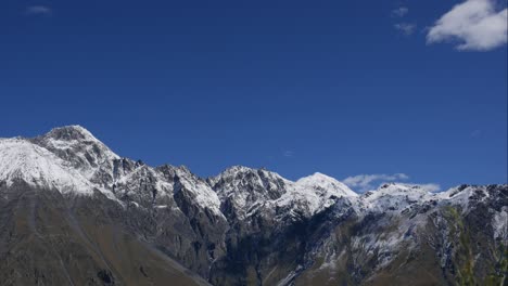 blue sky white clouds over snow mountains. puffy fluffy white clouds. cumulus cloud scape timelapse. winter blue sky time lapse. dramatic majestic amazing blue sky. soft white clouds form. clouds time lapse background