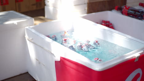 Ice-cold-drinks-sitting-in-a-ice-cold-container-on-a-hot-summer-day-at-a-festival,-matsuri,-in-Kyoto,-Japan-soft-lighting