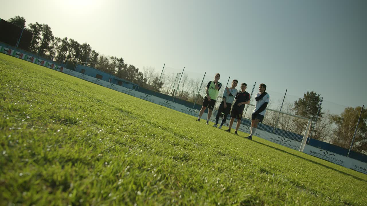 football soccer players prepare for a free kick on a sunny day, focus on the ball close to the camera