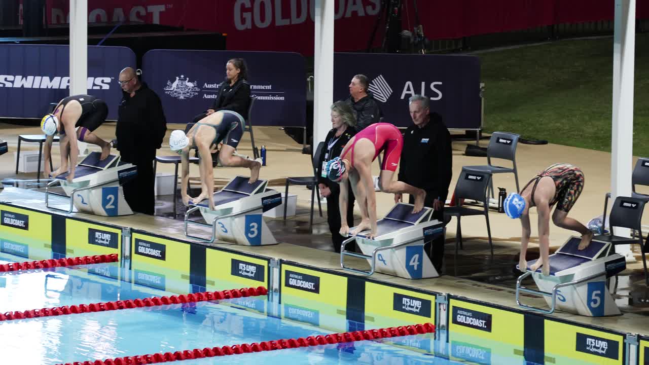 Sequence of a swimmer diving into a pool during a race