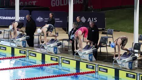 sequence of a swimmer diving into a pool during a race