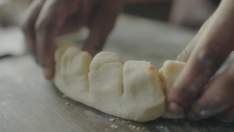 hands shaping dough with filling for baking