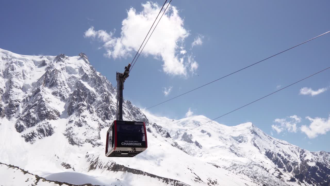 AIGUILLE DU MIDI CHAMONIX MONT BLANC, FRANCE on JUNE 2019. Cable car cabin with tourists at high french mountain range landscapes at european ALPS