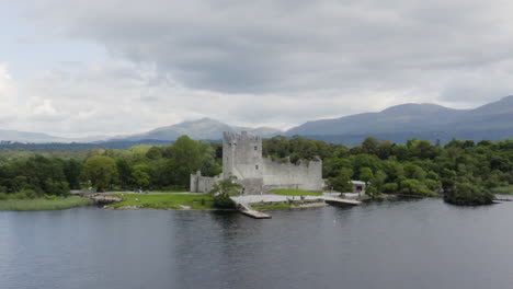 aerial - ross castle in killarney national park, ireland, forward wide rising shot