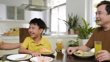 asian men and boy sitting at the table