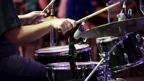 persona tocando la batería en concierto en vivo