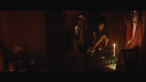 a man in hat checks the inside of the gypsy circus cart