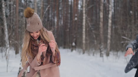 Happy-Couple-is-Playing-Winter-Game-Outside-Enjoying-Sunlight-and-Warm-Winter-Weather-in-the-Mountains.-Strong-Boy-is-Carrying-Girlfriend-on-His-Shoulders-and-Whirls-Her