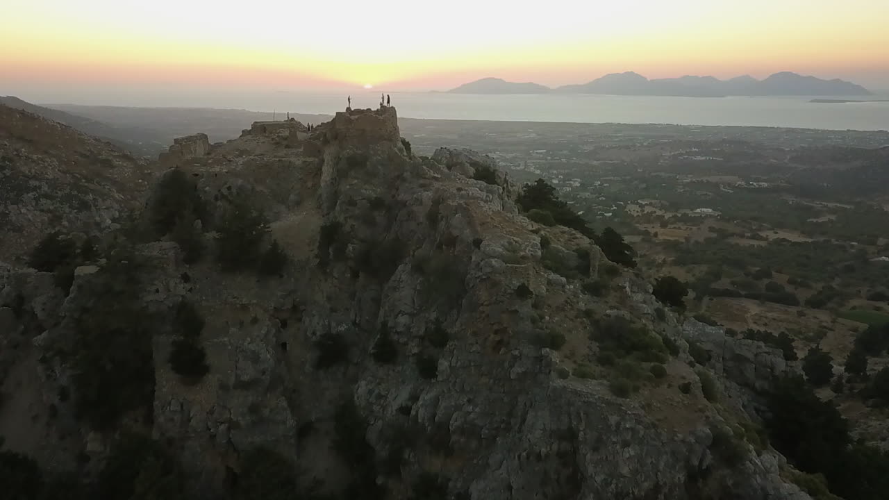 Aerial: Tourists explore ruins of clifftop fortification in Turkey