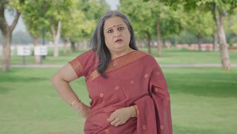 Angry-Indian-old-woman-looking-to-the-camera-in-park