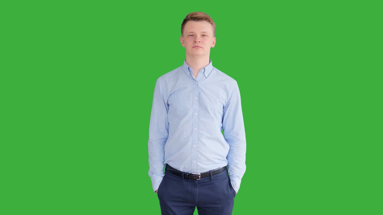 Young Caucasian Man Standing against Green Screen Background. Male Person Isolated on Chroma Key. Casual Business Professional Portrait