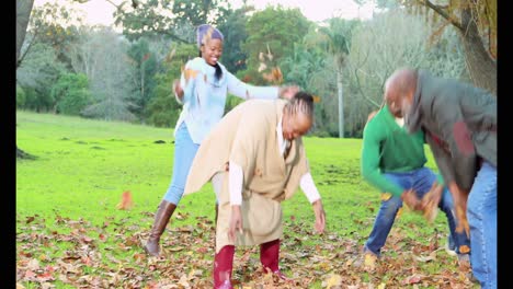 happy family tossing autumn leaves