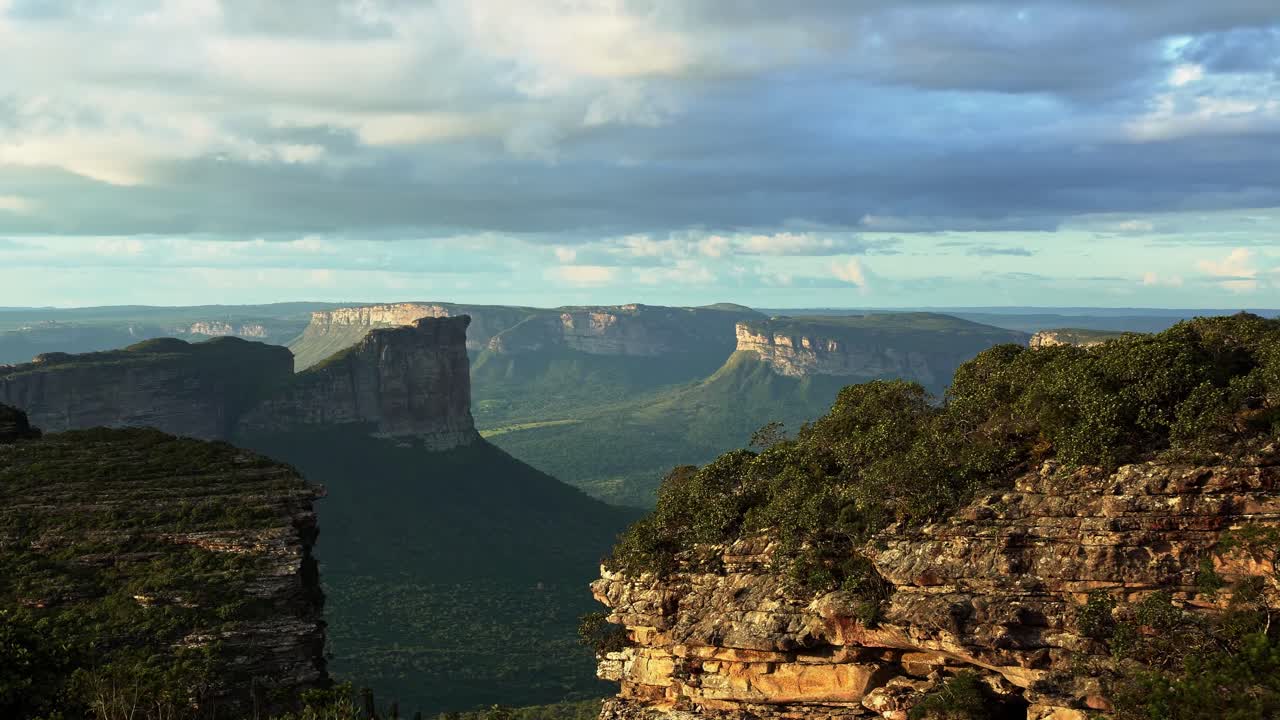 Handheld shot of the stunning Capao Valley with large plateaus from the top of Mount of Pai Inácio in the Chapada Diamantina national park in northern Brazil on a warm summer evening