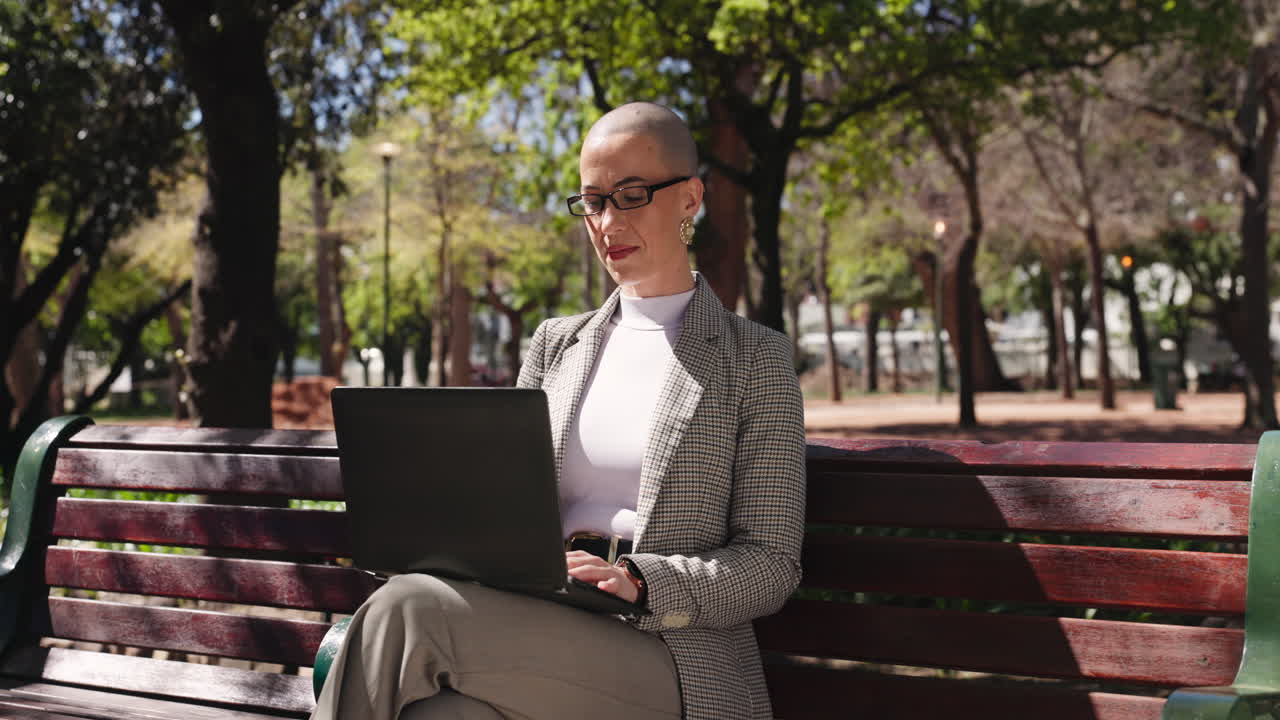Businesswoman Working on Laptop in Park