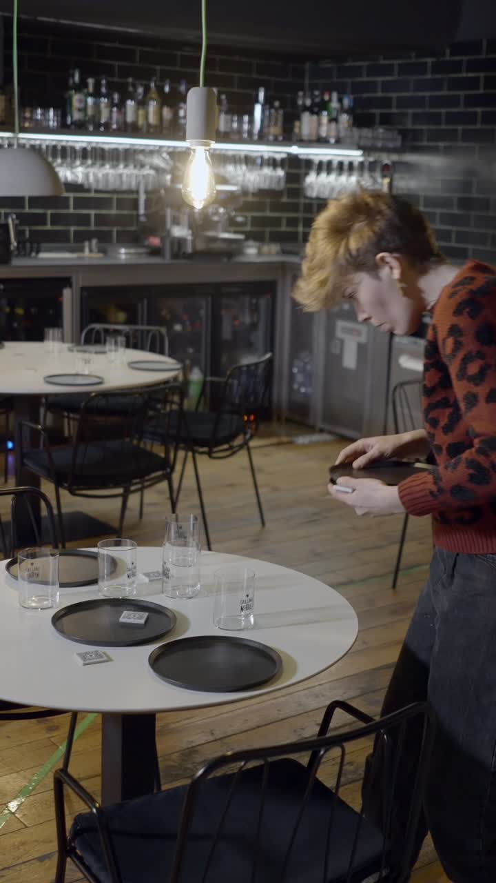 Man setting tables in a restaurant