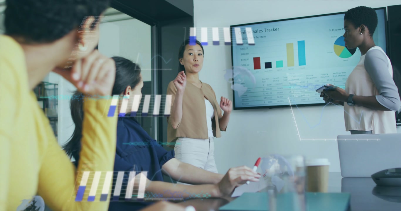 Asian presenter in meeting activating animated charts showing sales trends colleagues noting data