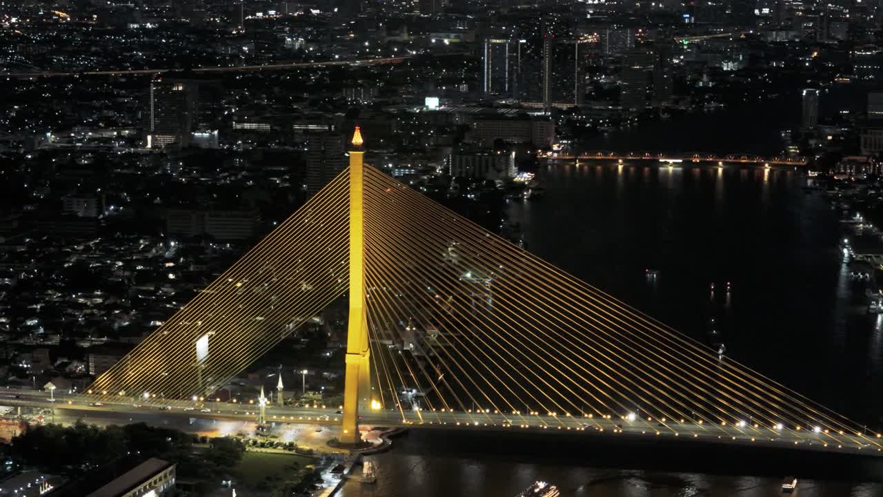 Fly over Chao Phraya River with view of Rama VIII Bridge at night
