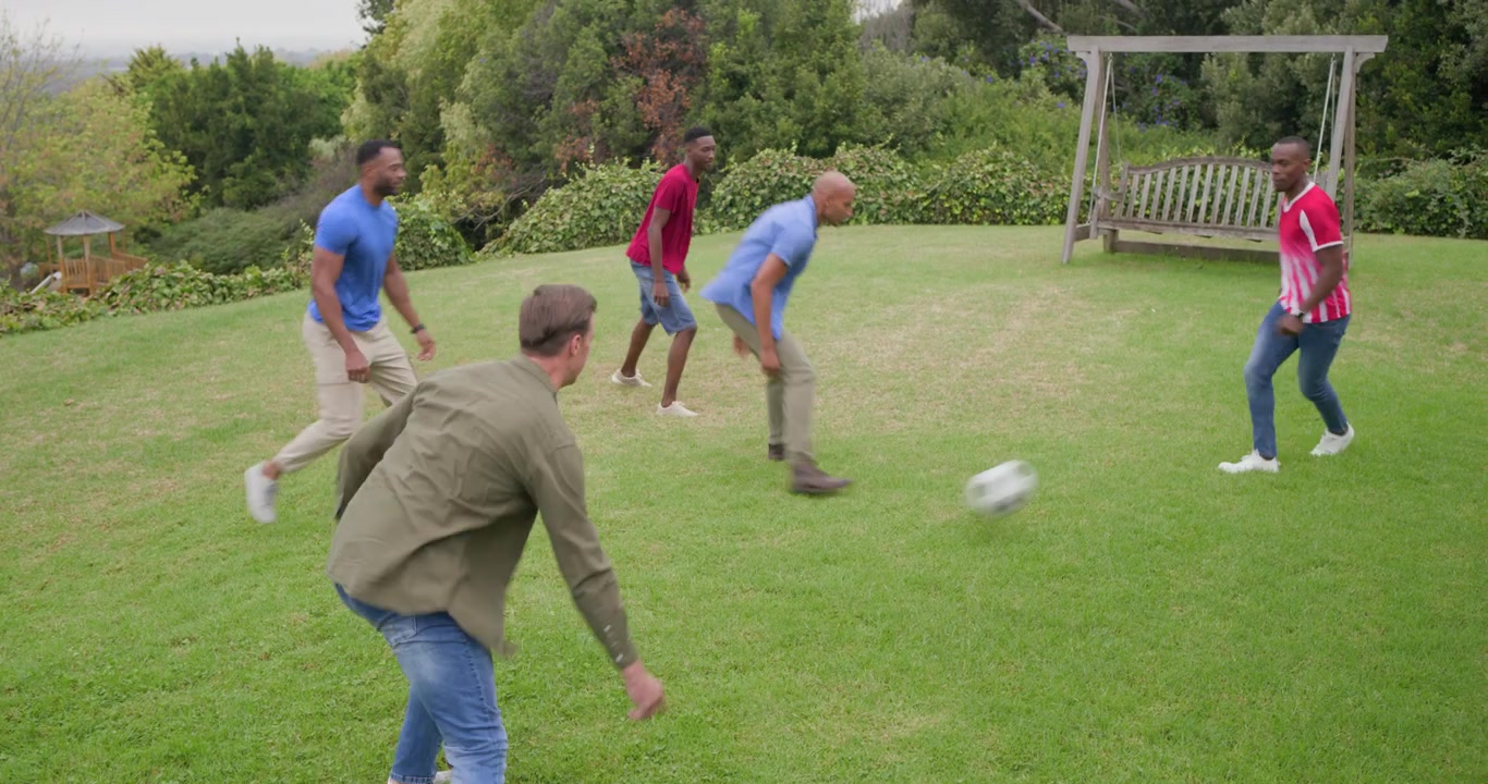 Five men starting with red shirt controlling soccer ball, practicing passing near bench on hillside