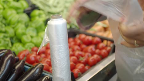 woman wrapping produce at grocery store