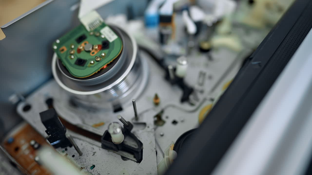 Inside of the VCR player close up. VHS mechanism rotates quickly and then cassette pops out