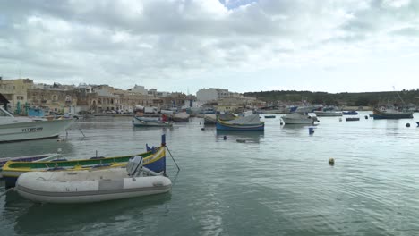 traditional fishing boats decorated with osiris eyes in the harbour of marsaxlokk