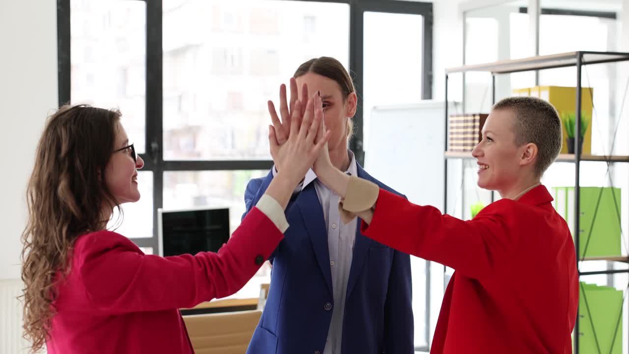 Colleagues give high five together after successful deal