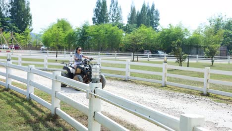 person training horse while riding an atv