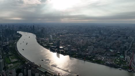 drone aerial view of buildings, cityscape and river in downtown