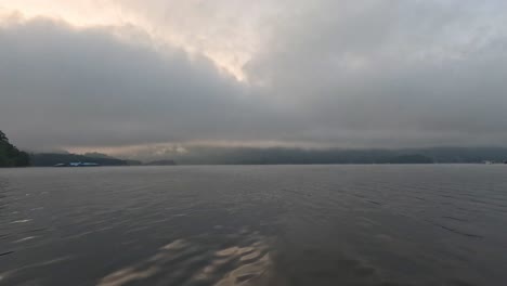 calm water surface with cloudy twilight sky