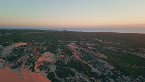 drone coastal dunes sunset. aerial blend urban interface with natural landscape