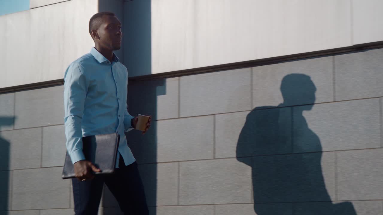 Businessman Walking with Laptop and Coffee