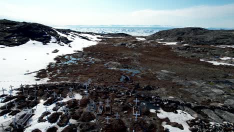 Hundreds-of-white-crosses-on-permafrost,-graveyard-in-Ilulissat,-Greenland