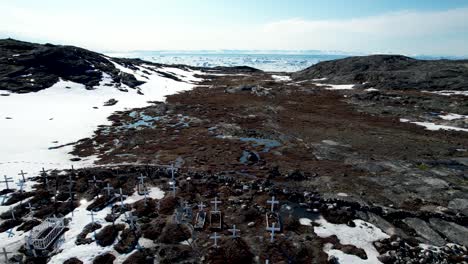 hundreds of white crosses on permafrost, graveyard in ilulissat, greenland