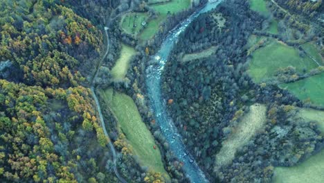 aerial view of rocky river flowing in countryside on autumn day