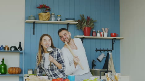 couple cooking and kissing in the kitchen