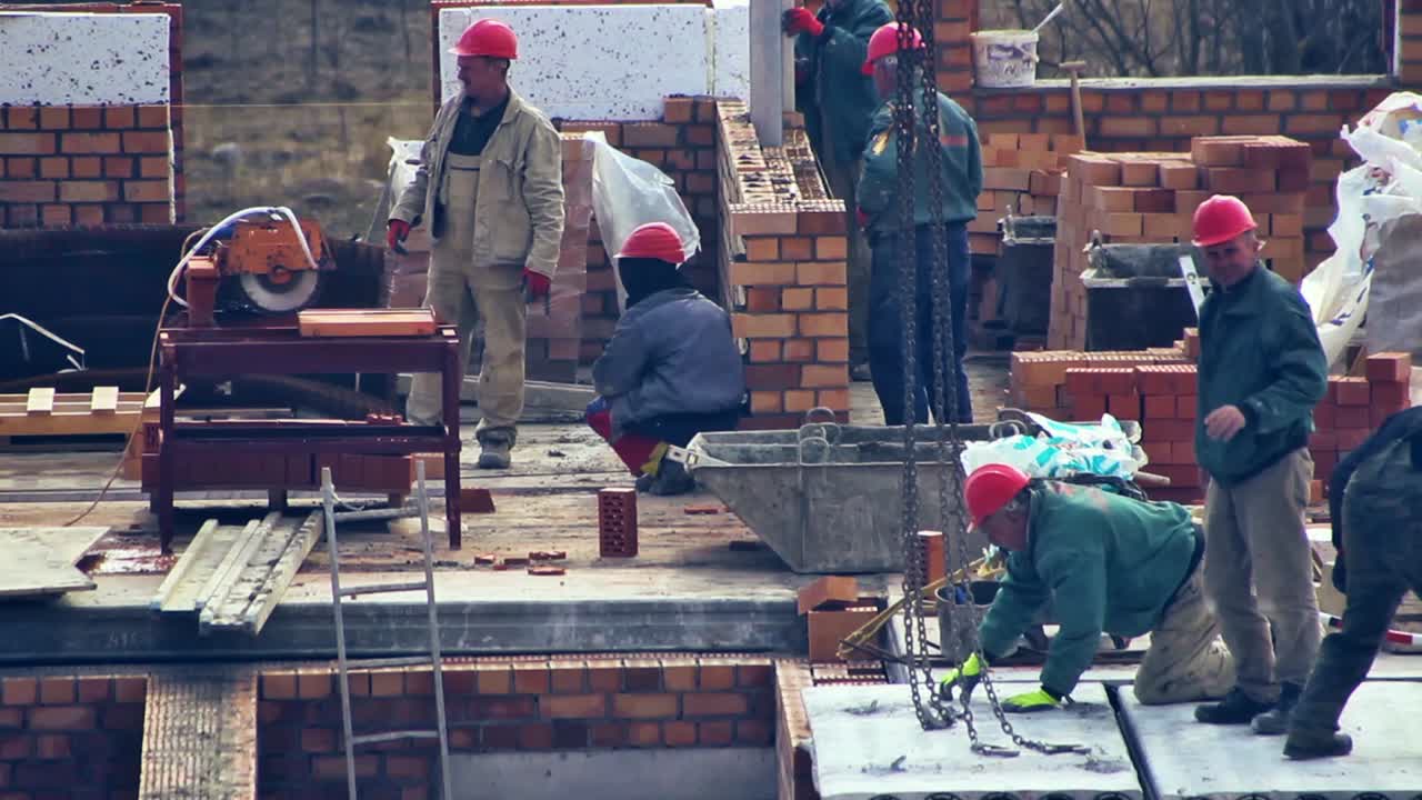 Close Up of Builders with a Red Helmets on a Building Under Construction. Time Lapse
