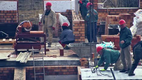 close up of builders with a red helmets on a building under construction. time lapse