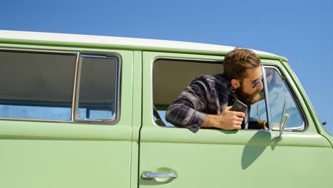 young stylish man looking through van window 4k