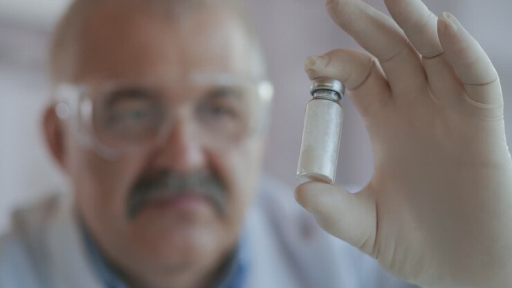 Un farmacista tiene un medicinale con polvere bianca in fiale di vetro. Un nuovo farmaco per combattere virus e malattie. Medicina per il coronavirus. Anestetico. Filmato 4k di alta qualità.