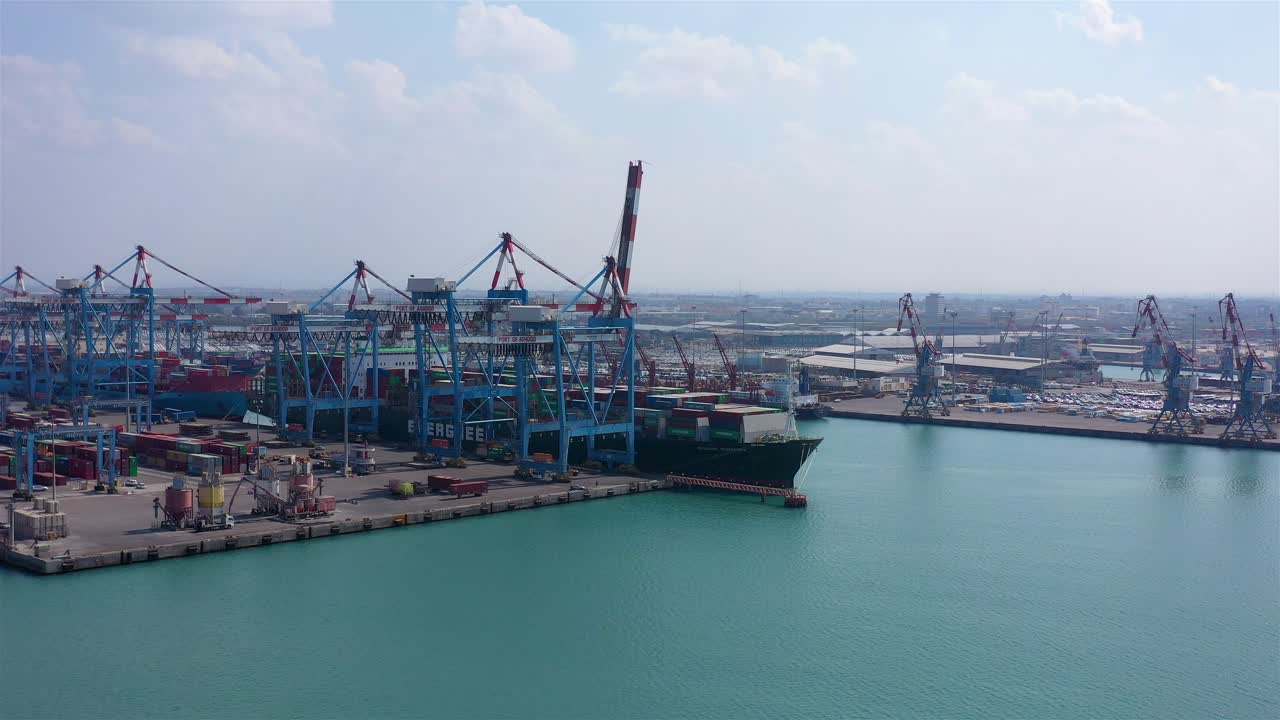Aerial View of a Large Container Ship Docked at a Commercial Port Terminal