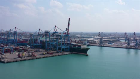 aerial view of a large container ship docked at a commercial port terminal