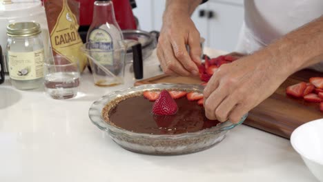 adding strawberry slices to cheesecake homemade dairy-free vegan plant based cheesecake diet healthy eating