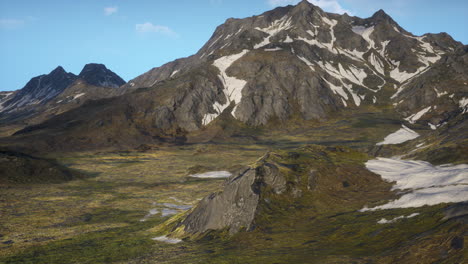 a scenic view of a mountain range with snow-capped peaks.