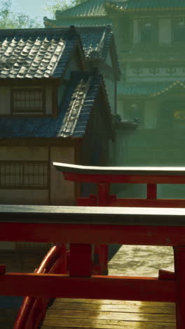 a red torii gate in a traditional japanese village