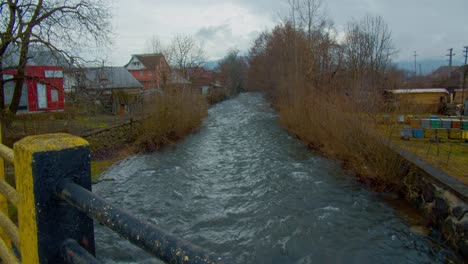 view from a bridge, over a small river in a old village