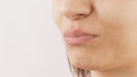 close-up portrait of woman chewing gum.