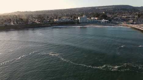 aerial view of santa cruz boardwalk and beach california with surfers shot in 4k high resolution