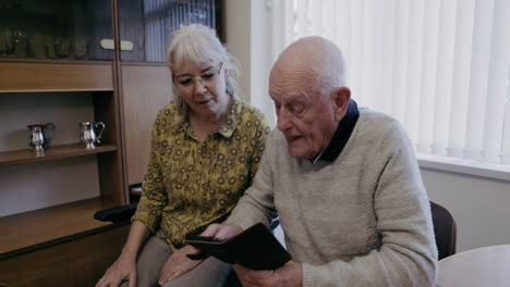 senior man and woman using a tablet